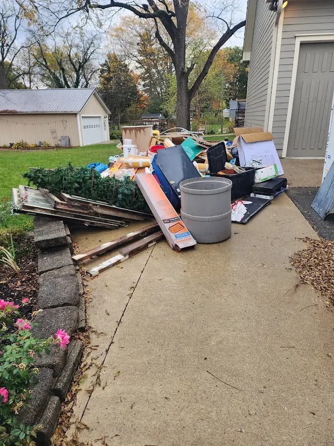 Dumpster being loaded with debris for Estate Cleanout Dumpster Rental in Fredonia